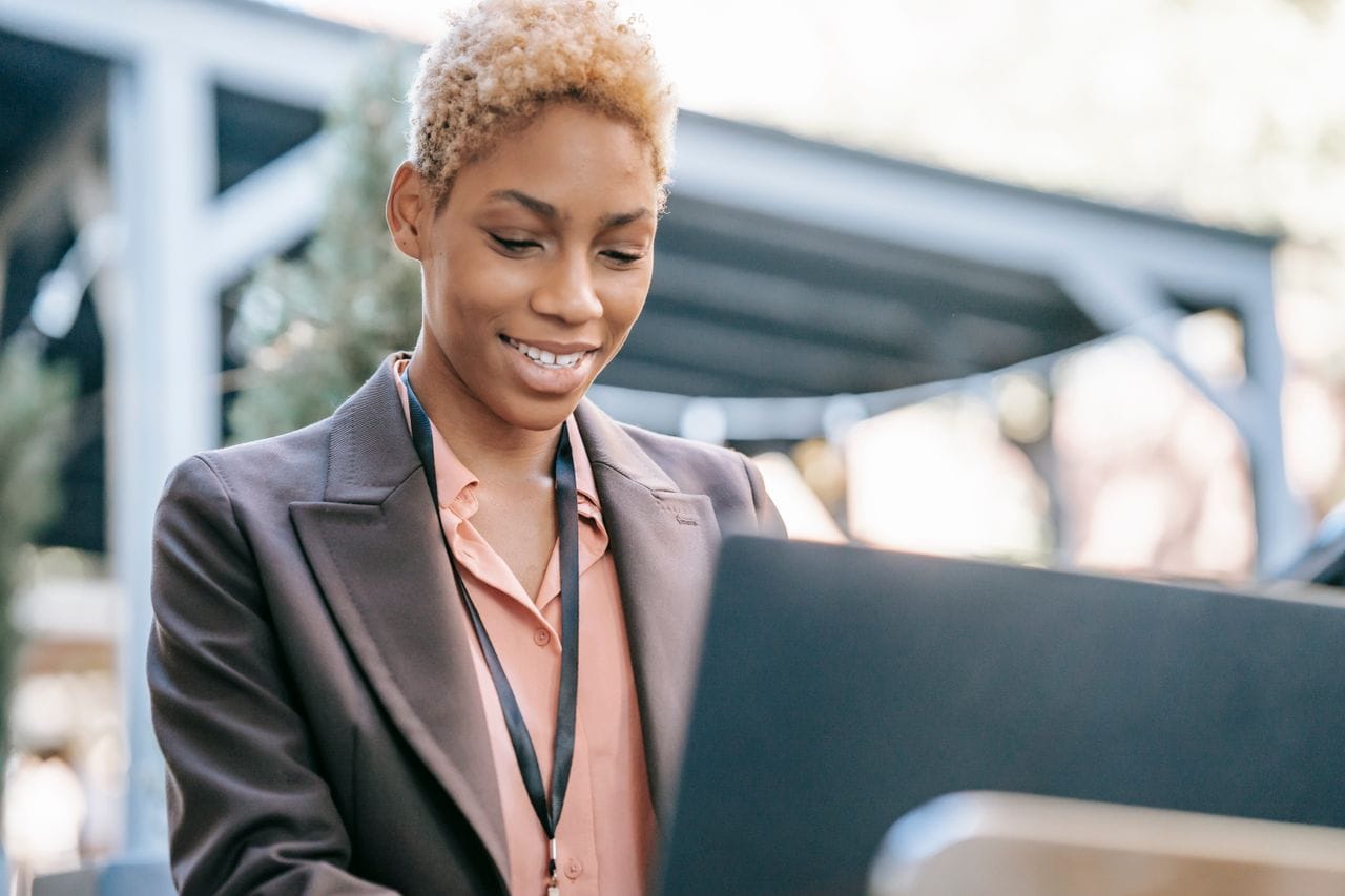 A business owner updating her own website on a laptop.